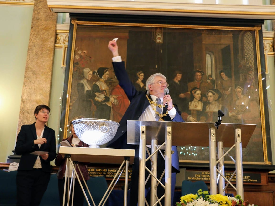 The Mayor draws the charity raffle at the lectern of the main hall.