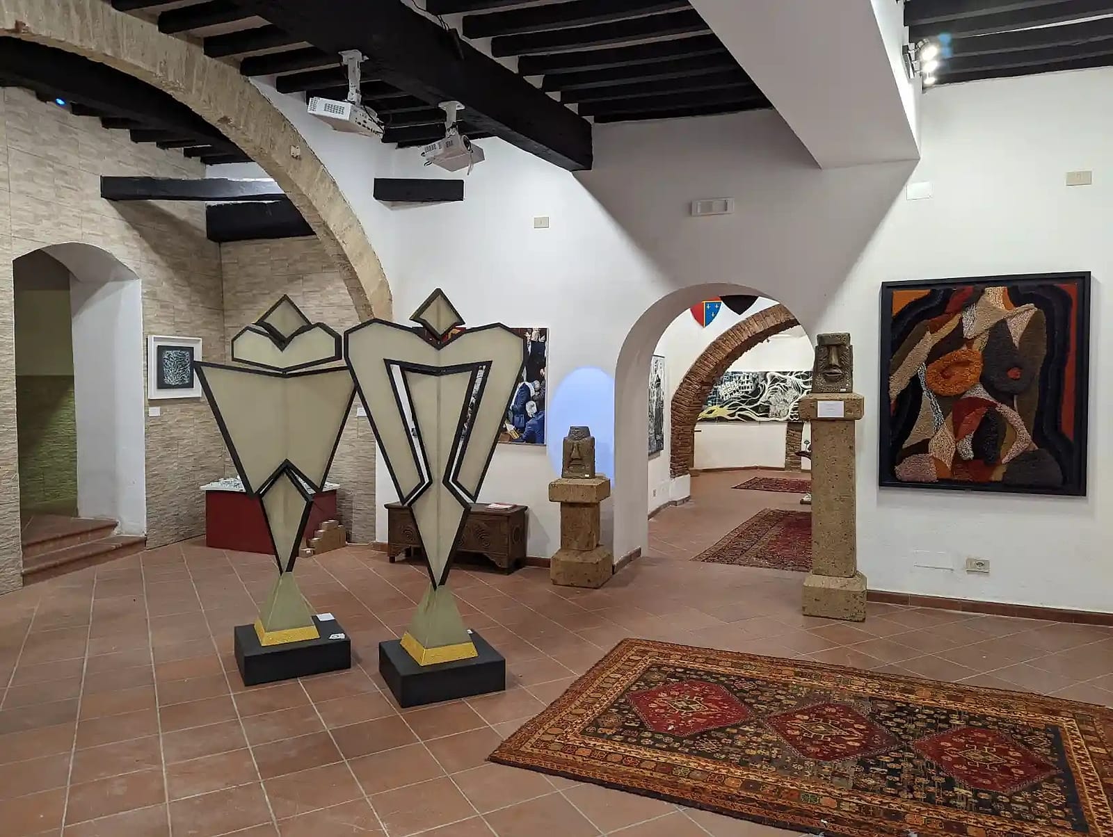 Two sculptures holding the middle of the arched gallery.