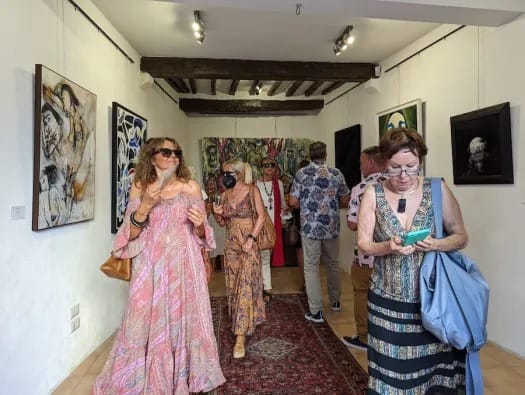 Visitors in the timber-beamed gallery at the Chianciano Art Museum.