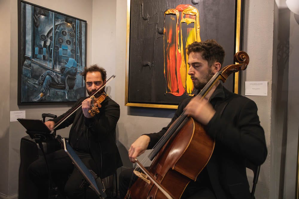 Violin and cello playing among the paintings.