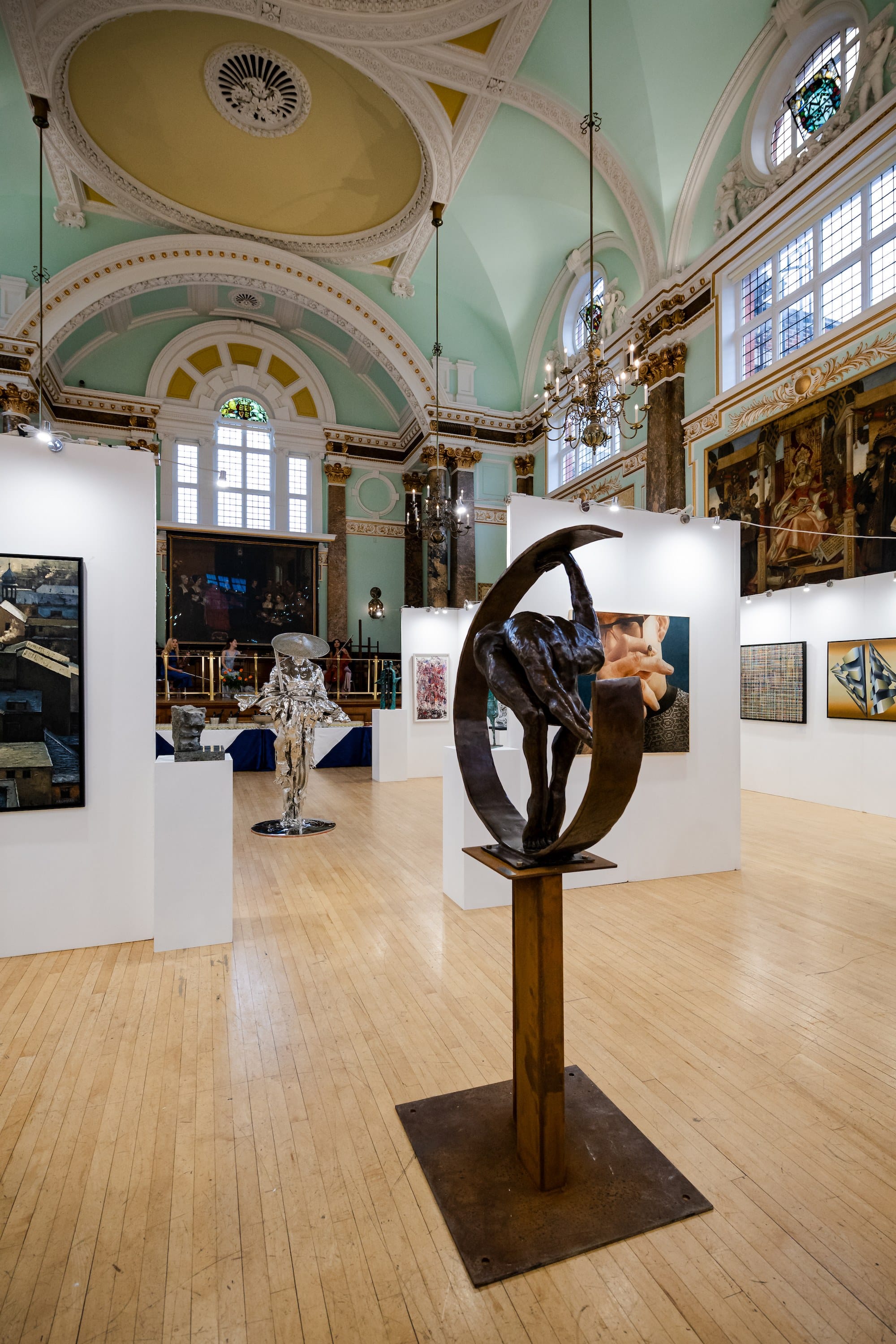 A sculpture of an iron ring on a tall stand, in the main hall beneath its painted dome.
