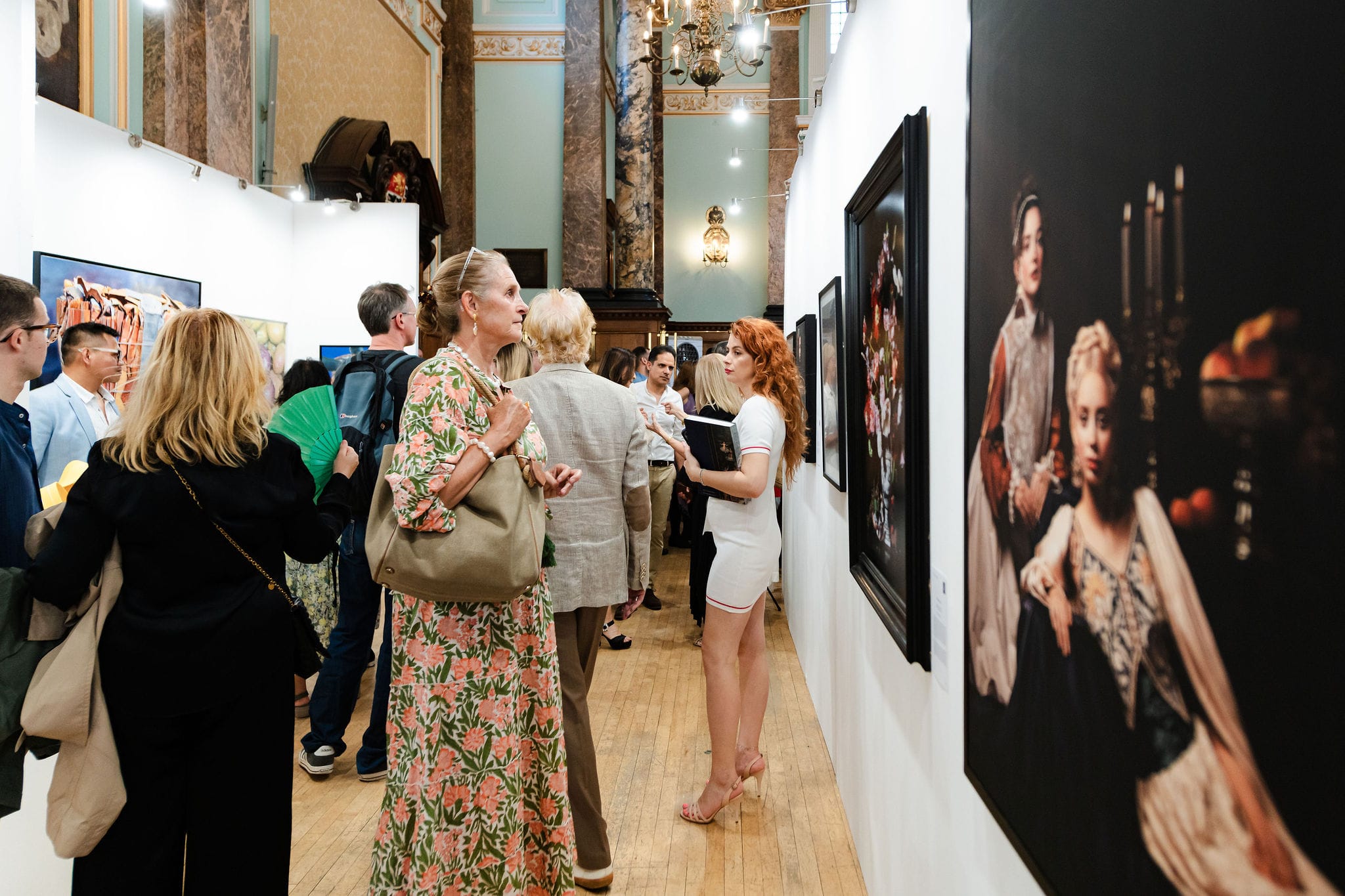 Visitors along the photography wall.